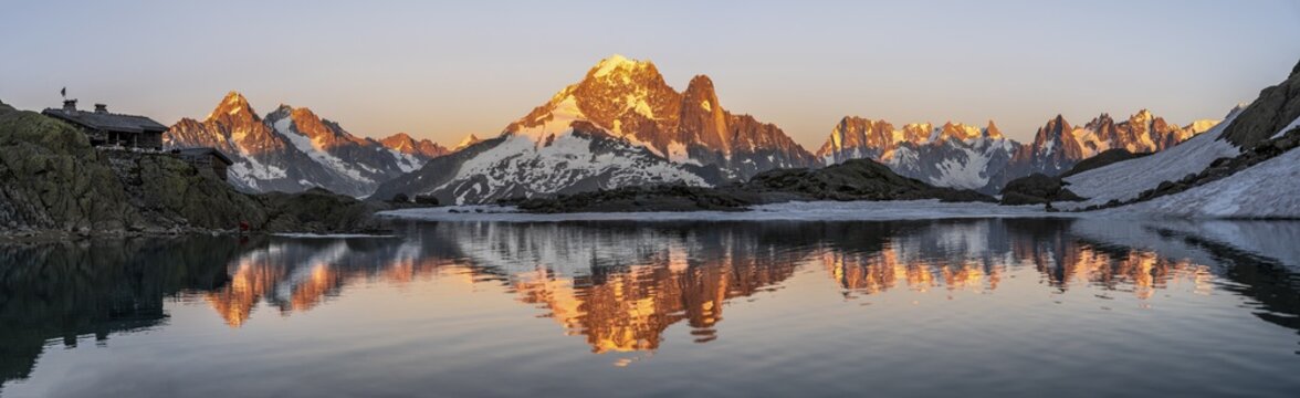Evening mood, mountain landscape at sunset, alpenglow, water reflection in Lac Blanc with mountain hut Refuge du Lac Blanc, mountain peak, Aiguille Verte, Grandes Jorasses, Aiguille du Moine, Mont Blanc, Mont Blanc massif, Chamonix-Mont-Blanc, Haute-Savoie, France