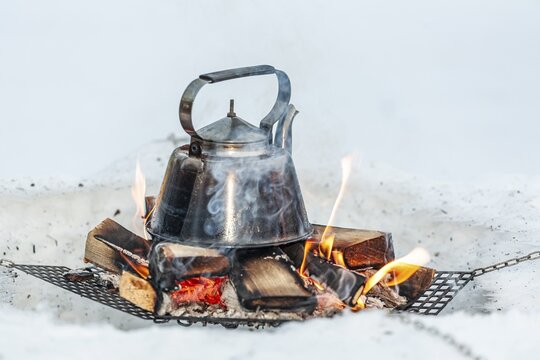 Coffee pot standing on fireplace, water pot, traditional, Sami culture, Jokkmokk winter market, Jokkmokk, Lapland, Sweden