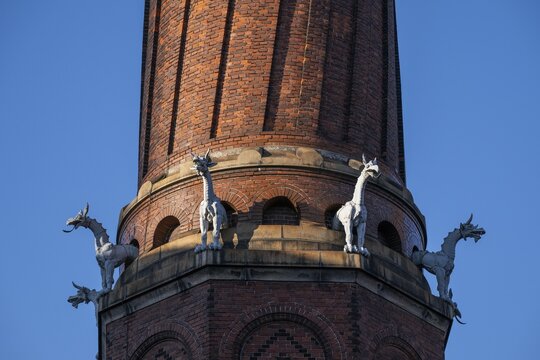 Detail, coiled industrial chimney by Carl Jacobsen, Vilhelm Dahlerup and PS Beckmann with replicas of the chimeras or gargoyle sculptures from Notre-Dame, Carlsberg district, Copenhagen, Denmark