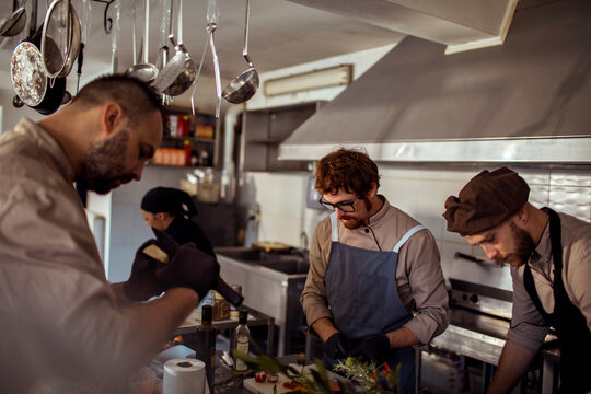 Adult chefs working in a restaurant kitchen