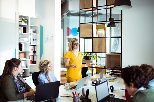 Young woman leading team meeting in office