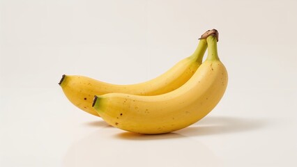 Two fresh, yellow curved fruits known as bananas, popular as food and drink options.