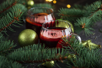 Two Glass Mugs of Mulled Wine with Christmas Decor and Fairy Lights