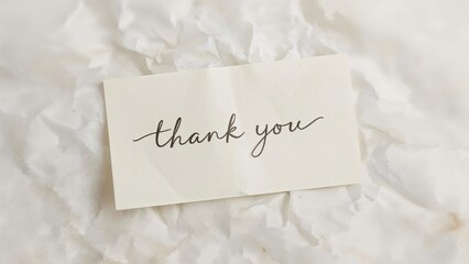 Hand writing thank you on piece of paper
