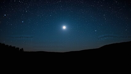 Bright full moon and stars illuminate a clear night sky above silhouette of trees and hills, creating a serene and expansive celestial scene.