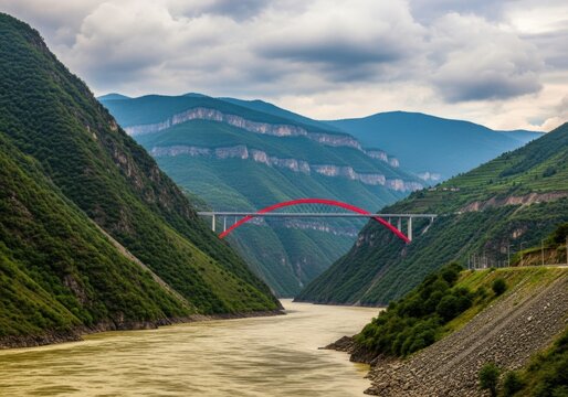 Majestic bridge spans a mighty river between verdant mountains
