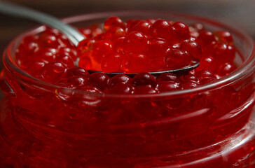 Bright Red Salmon Roe Caviar in a Glass Jar with Spoon