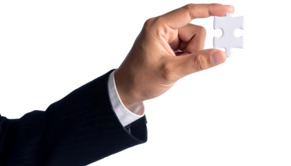 A person holding the final puzzle piece, signifying completion and solution. The hand with the white puzzle piece represents the final step