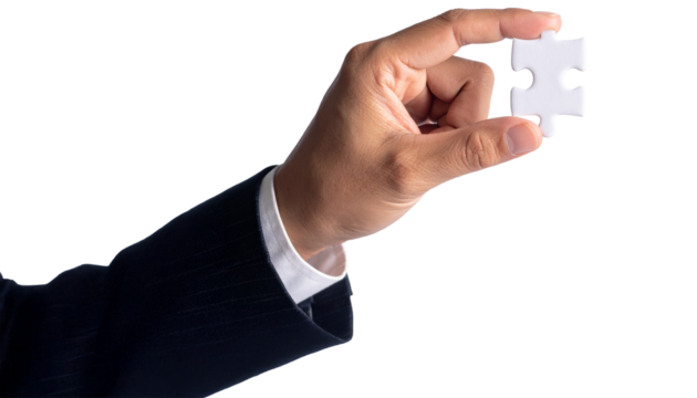 A person holding the final puzzle piece, signifying completion and solution. The hand with the white puzzle piece represents the final step