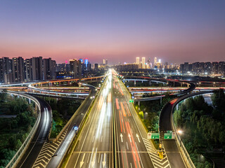 Fototapeta premium Aerial views of urban highways and interchanges at sunrise