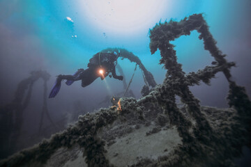 Scuba diver explores the sunken ship Tsesarevich at 50 m depth near Tarkhankut Peninsula in the...