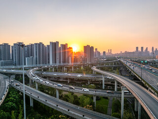 Obraz premium Aerial views of urban highways and interchanges at sunrise