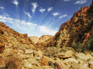 Wispy high altitude cirrus clouds over the Desolate Rocky environment in the Fish River Canyon of Namibia