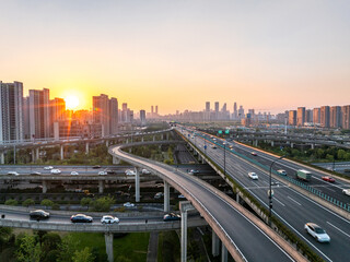 Obraz premium Aerial views of urban highways and interchanges at sunrise