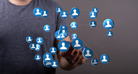 Concept of social network and global connections visualized. Hand touching digital network of people icons, representing communication and socia