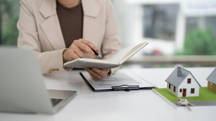 Real Estate Agent Reviewing Property Documents Home Models Desk Office Professional Sales Consultant Business Transaction Planning Client Meeting
