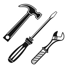 A classic set of three essential hand tools including a claw hammer a flathead screwdriver and an adjustable wrench isolated on white