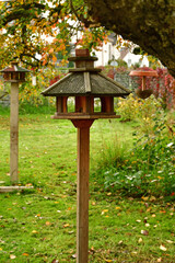 bird feeder houses in a German garden in autumn