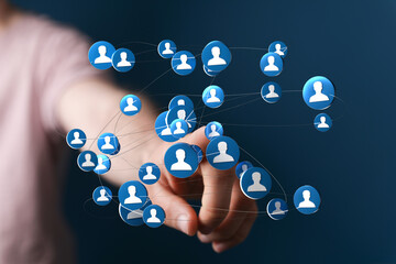 Person touching a digital network of people icons, representing social connection, communication and teamwork. Great for business and technology