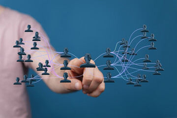Abstract image showing interconnected human icons, symbolizing connection, teamwork and community...