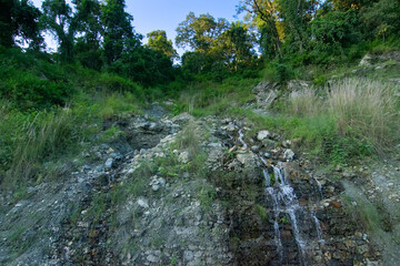 Small waterfall, cascade of water flowing over a rocky mountain surface , sikkim, India. Sikkim is full of small and large waterfalls.