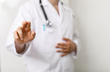 A medical professional points at the camera, potentially indicating something or diagnosing, health concept