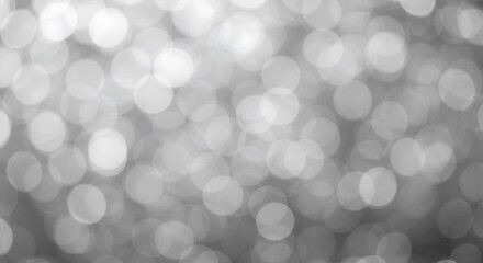 Abstract background of blurred white bokeh lights, creating a soft, dreamy, and magical effect with a shallow depth of field
