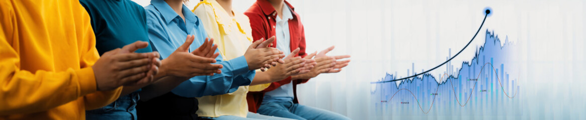 Engaged business professionals applaud during a presentation, highlighting success and...