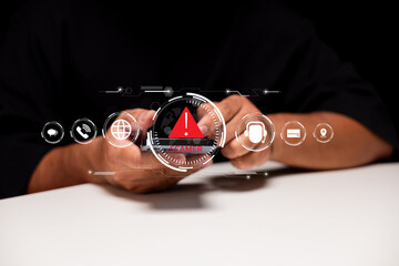 A person holds a device displaying a warning alert, suggesting a focus on gaming or digital engagement in a technological context.