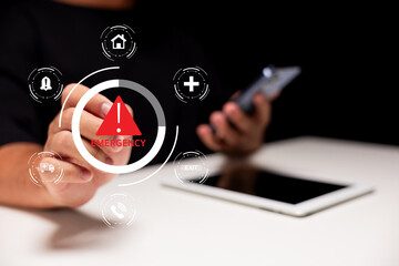 A hand points towards an emergency alert icon on a digital interface, highlighting the importance of quick response in critical situations.