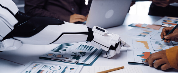 A modern business meeting showcasing a robotic arm assisting in data analysis, highlighting...