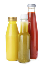Bottles with different tasty sauces isolated on white