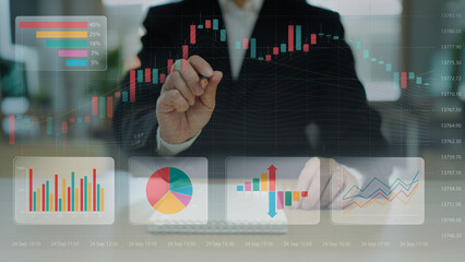 Close-up of hand with pen analyzing 3D chart, diagrams on paper. Business analytics of company...