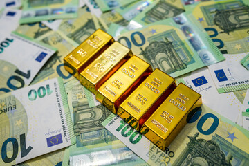 Gold bullion with euro notes, financial prosperity, global economy and investment concept