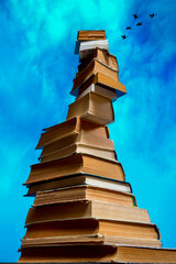 A tall stack of books going to heaven