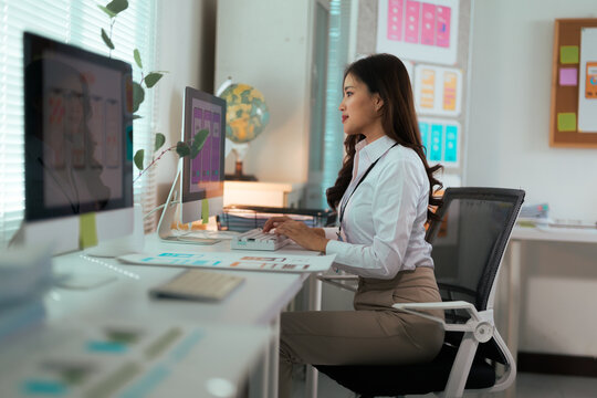 Asian woman developing UI UX application design on computer