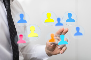 Hand of a businessman interacting with a network of people icons. Concept of connection, community, and human interaction. Ideal for business, s