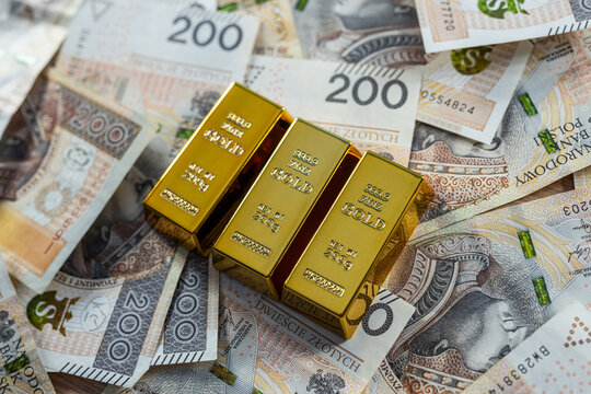 Gold bar with Polish zloty banknotes, investment in precious metals, wealth, savings and finance concept