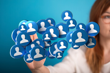 Woman holding floating social media icons, representing networking, connection, and online communities. Symbolizing digital interaction and comm