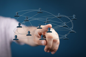 Hand pointing at a network of connected people, symbolizing teamwork, communication, and digital connections in the modern world. Perfect for bu