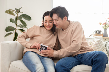 Expectant Couple Happily Shares Ultrasound Image in Cozy Living Room Setting