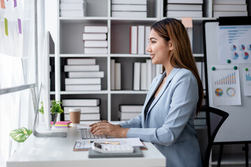 Accounting business concept, Accountant woman working on computer and calculator with paperwork of finance