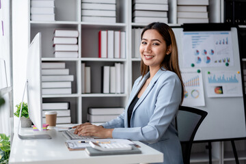Accounting business concept, Accountant woman working on computer and calculator with paperwork of finance