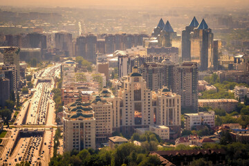 Scenic view of Almaty, Kazakhstan, as seen from Kok-Tobe Mountain at sunset, with its futuristic skyscrapers reflecting in the evening sun