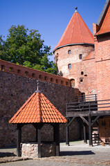 Historic brick castle with red roof and tower, Bytow, Poland