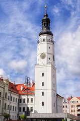 Fototapeta premium Historic clock tower stands tall against blue sky. Glogow, Poland