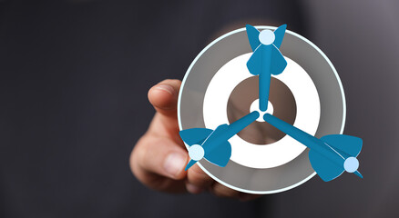 Hand pointing at target with darts, concept of goal achievement, business strategy, successful targeting. Symbol of precision, focus and hitting