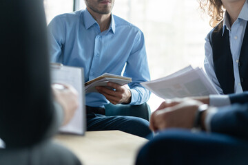 Close up of businesspeople cooperate work together discussing company financial statistics