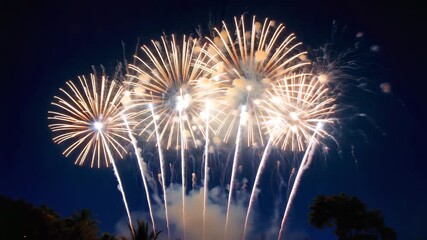 Vibrant golden chrysanthemum fireworks explode against a deep twilight sky with streaks of white