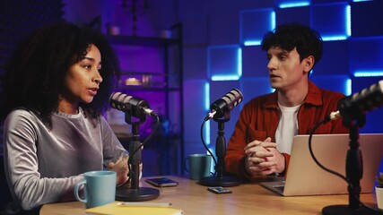 African American woman podcast host talking politics with a colleague in studio